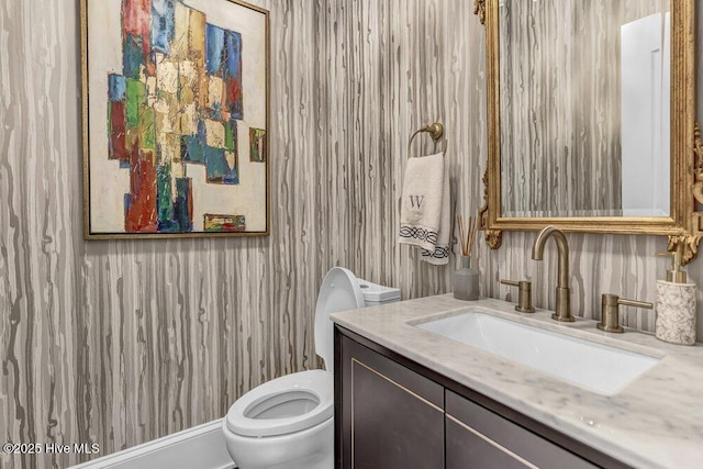 bathroom with toilet and vanity