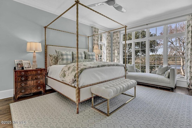 bedroom with baseboards, dark wood finished floors, and crown molding