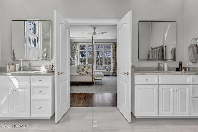 ensuite bathroom with a sink, two vanities, ensuite bath, and a ceiling fan