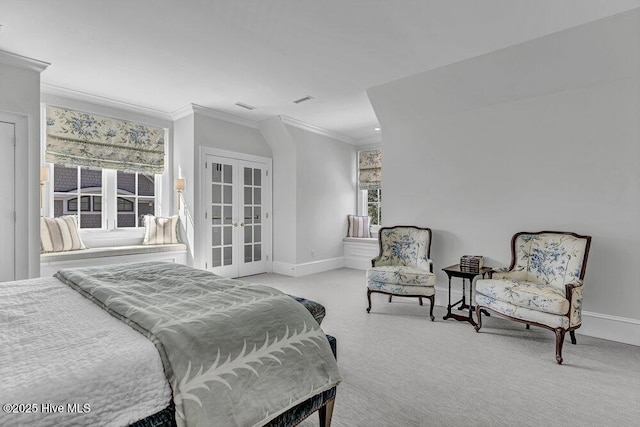 bedroom with baseboards, french doors, crown molding, and light colored carpet