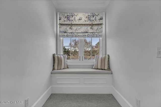 interior space featuring carpet floors, baseboards, and ornamental molding