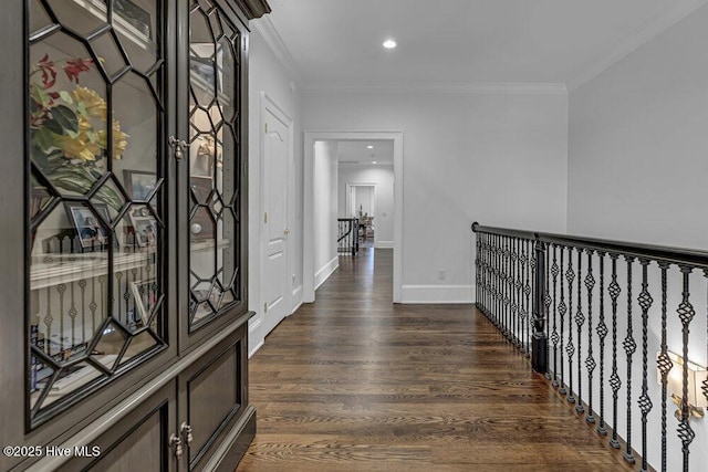 hallway with ornamental molding, dark wood-style flooring, recessed lighting, and baseboards