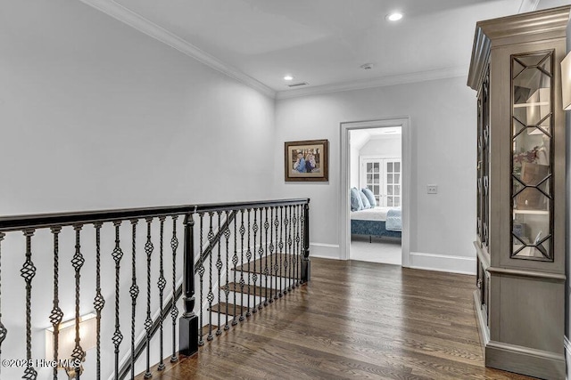 hallway featuring dark wood-style flooring, crown molding, recessed lighting, an upstairs landing, and baseboards