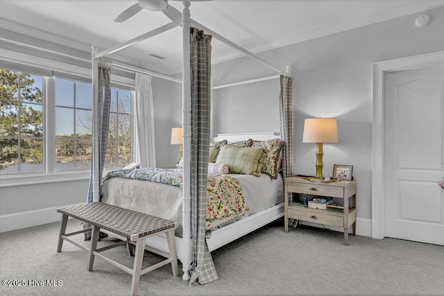 carpeted bedroom featuring ornamental molding, visible vents, ceiling fan, and baseboards