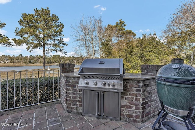 view of patio with a water view, grilling area, and area for grilling