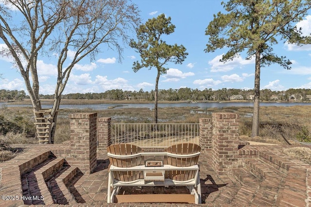 view of patio with a water view