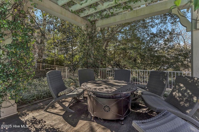 deck with outdoor dining space and a pergola