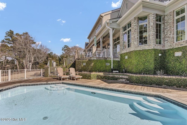 view of swimming pool featuring fence and a fenced in pool