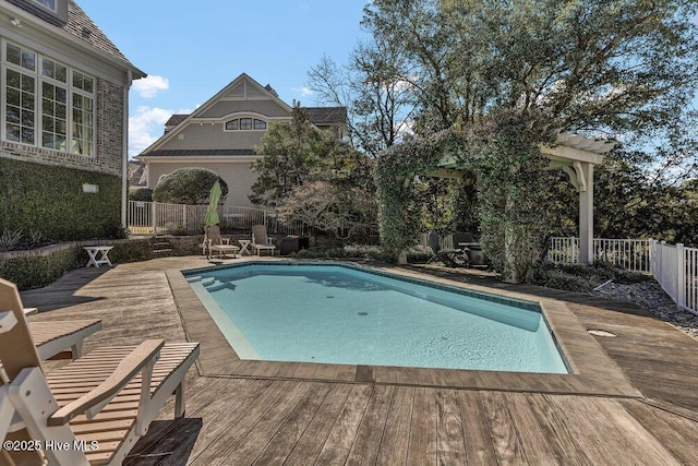 view of swimming pool featuring a fenced in pool, a fenced backyard, and a deck