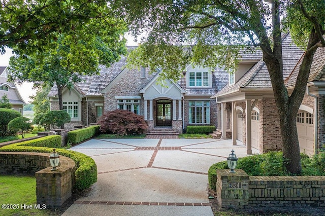 view of front of home with driveway and brick siding