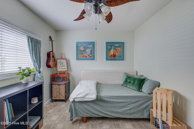 bedroom featuring baseboards, a ceiling fan, and light colored carpet