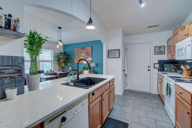 living area featuring light wood-style floors, ceiling fan, visible vents, and vaulted ceiling