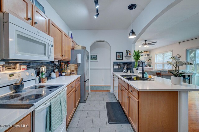 kitchen with visible vents, dishwasher, decorative light fixtures, light countertops, and a sink