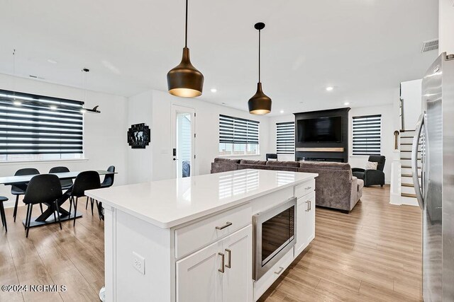 dining room featuring light wood-type flooring and baseboards