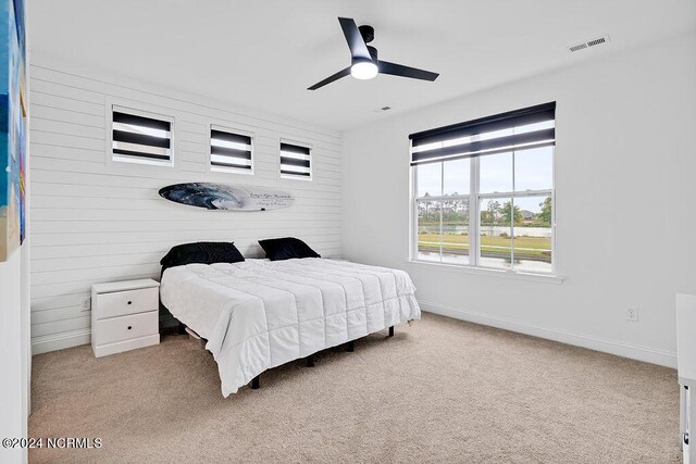 bathroom featuring visible vents, baseboards, a spacious closet, a shower stall, and tile patterned floors