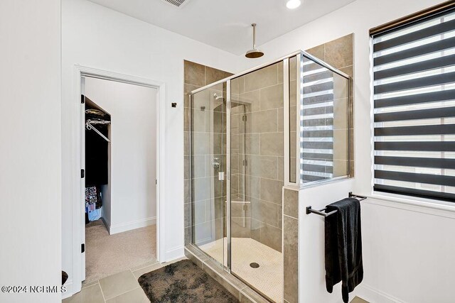 empty room with visible vents, light wood finished floors, and baseboards