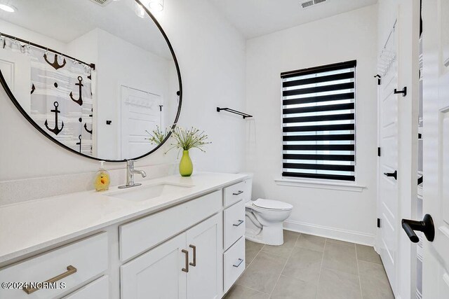 bedroom with light carpet, a water view, baseboards, and visible vents