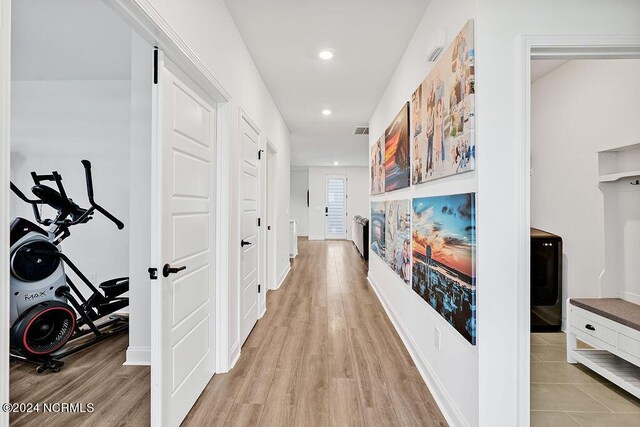 living area featuring baseboards, stairway, wood finished floors, a fireplace, and recessed lighting