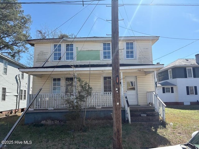 view of front facade with a porch and a front lawn