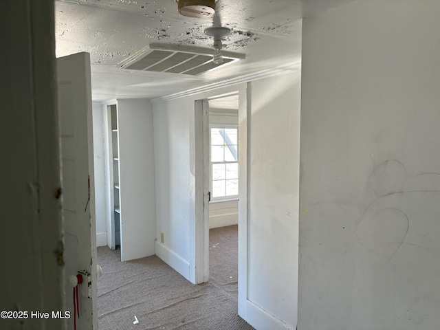 hall with light carpet and visible vents