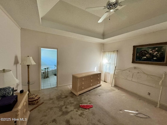 bedroom featuring ornamental molding, a raised ceiling, light colored carpet, and a textured ceiling