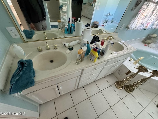 bathroom with double vanity, tile patterned flooring, and a sink