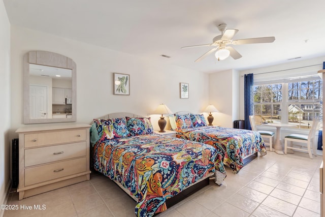 bedroom featuring light tile patterned floors, visible vents, and a ceiling fan