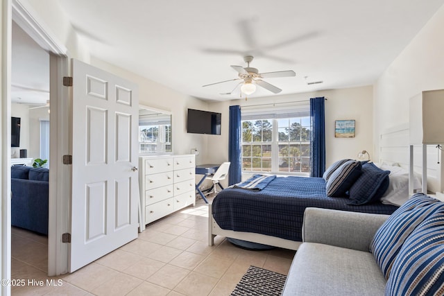 bedroom with ceiling fan and light tile patterned flooring