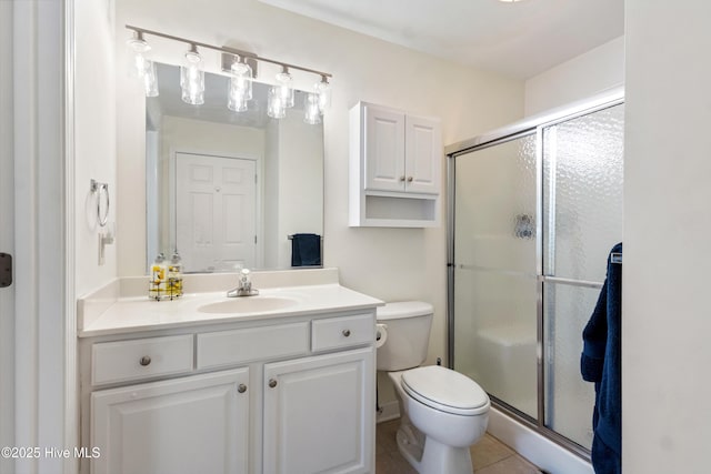 bathroom featuring vanity, tile patterned flooring, a shower stall, and toilet