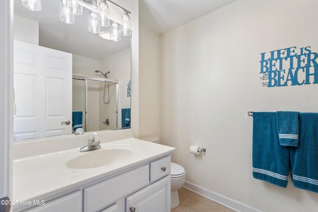 full bath with toilet, an enclosed shower, vanity, baseboards, and tile patterned floors