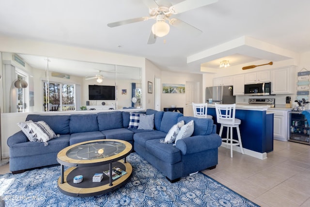 living room featuring light tile patterned floors and a ceiling fan