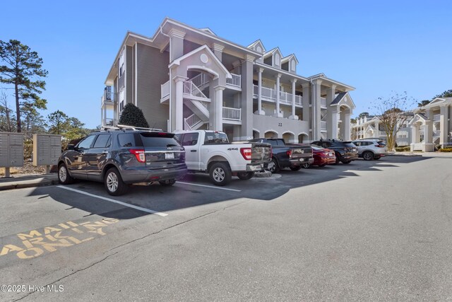 view of building exterior with uncovered parking