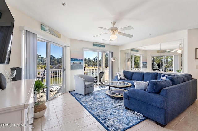 living room with a healthy amount of sunlight, light tile patterned floors, and a ceiling fan