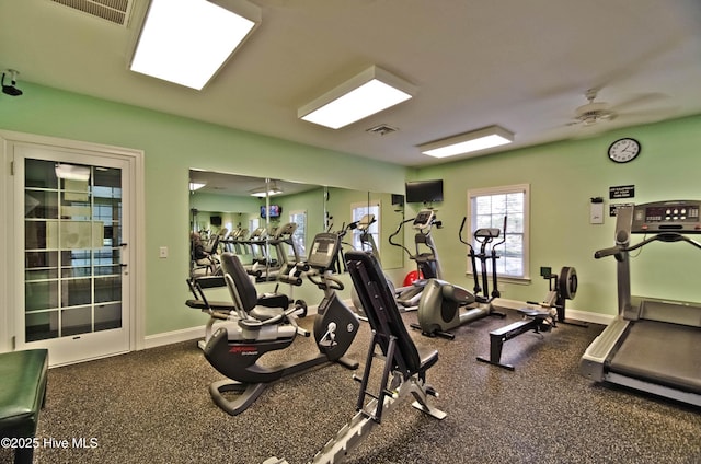 exercise room featuring baseboards, visible vents, and a ceiling fan