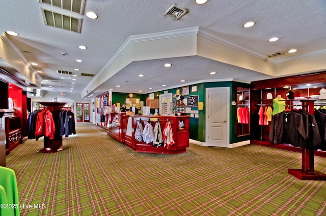 misc room featuring carpet floors, visible vents, and a textured ceiling