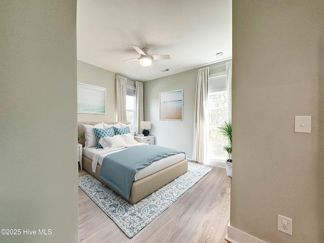 bedroom featuring light wood-style floors and ceiling fan