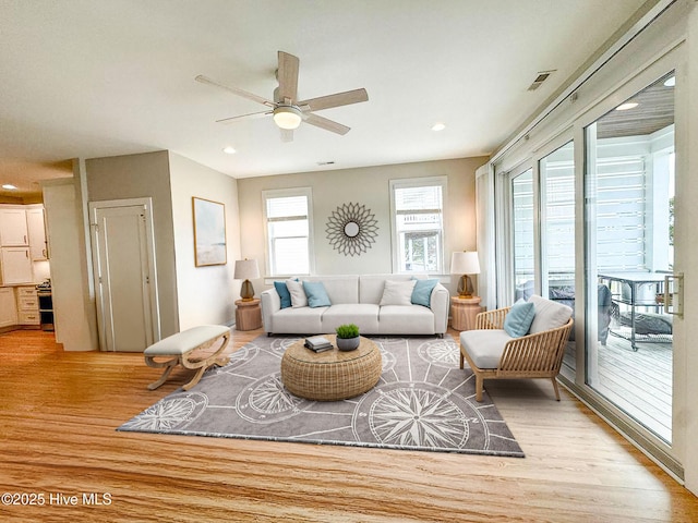 living area with visible vents, ceiling fan, light wood-style flooring, and recessed lighting