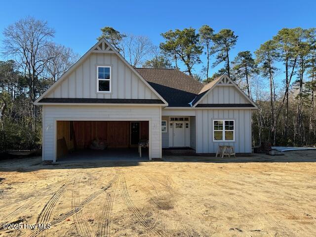 view of front of house with driveway, board and batten siding, and an attached garage