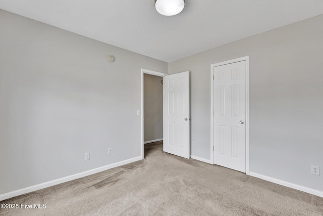 unfurnished bedroom with carpet and baseboards