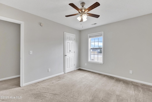 unfurnished room with ceiling fan, baseboards, and carpet flooring