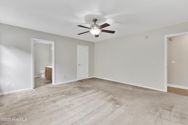 unfurnished room with light colored carpet, ceiling fan, and baseboards