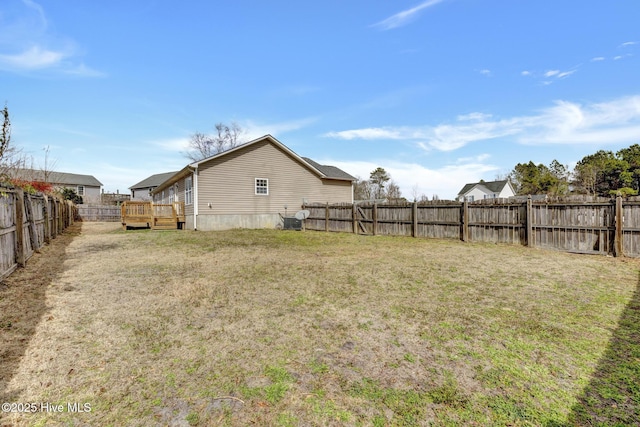 view of yard with a fenced backyard and a wooden deck