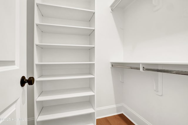 walk in closet featuring wood finished floors