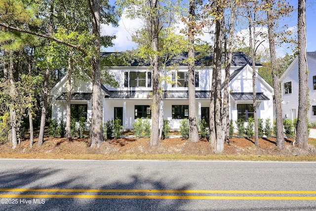 townhome / multi-family property with metal roof, a standing seam roof, and board and batten siding