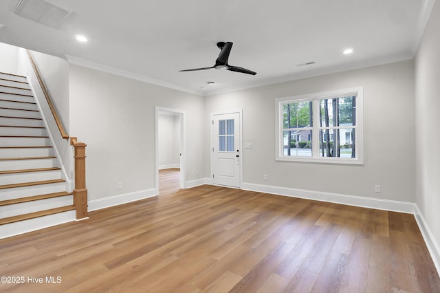 unfurnished living room featuring light wood finished floors, visible vents, a ceiling fan, and ornamental molding