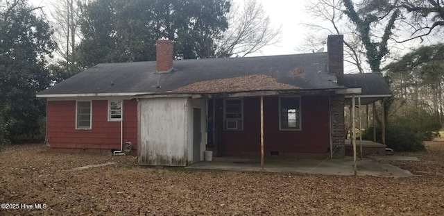 back of house with a patio area and a chimney