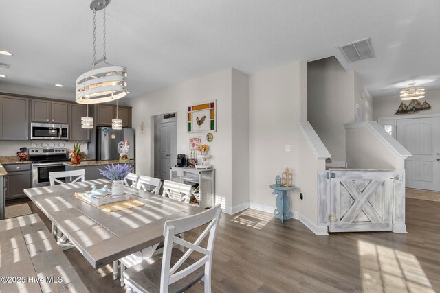 dining space with baseboards, visible vents, dark wood finished floors, and recessed lighting