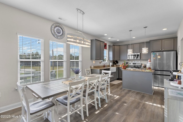 dining room with dark wood-style floors, visible vents, baseboards, and recessed lighting