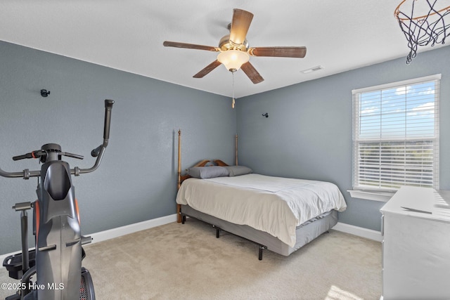 bedroom with light carpet, baseboards, visible vents, and a ceiling fan