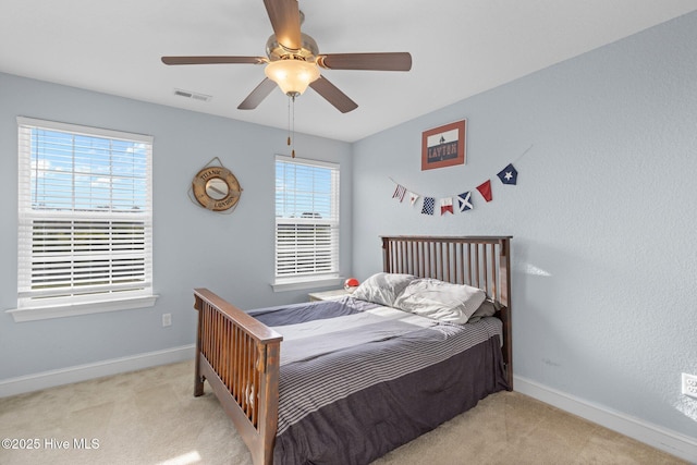 bedroom featuring visible vents, ceiling fan, light carpet, and baseboards